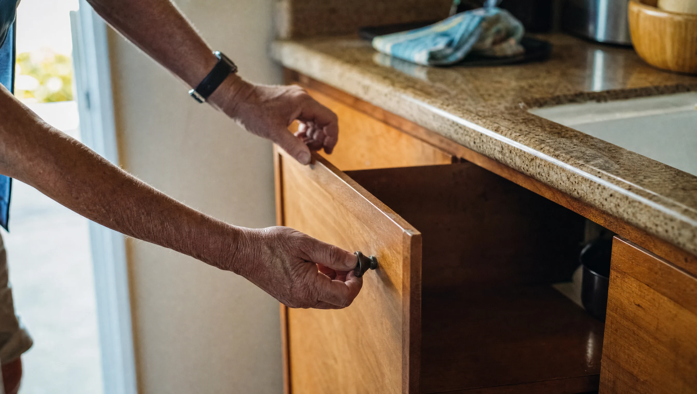 Renter checking a kitchen cabinet during a Los Angeles apartment showing