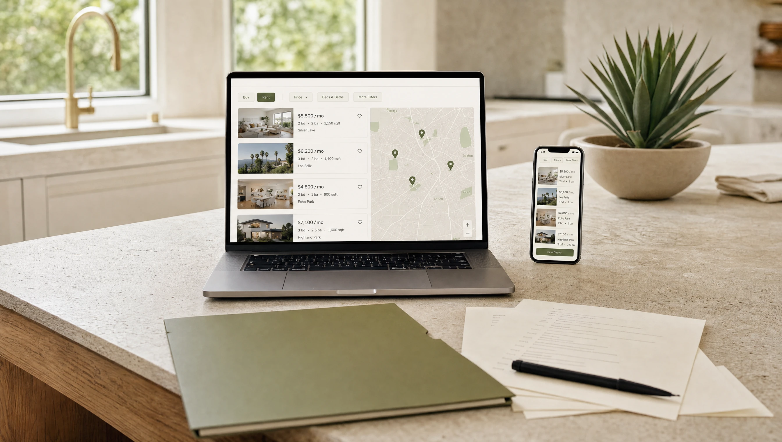 Laptop and phone showing a rental listings portal on a bright kitchen counter for the Complete Rental Package