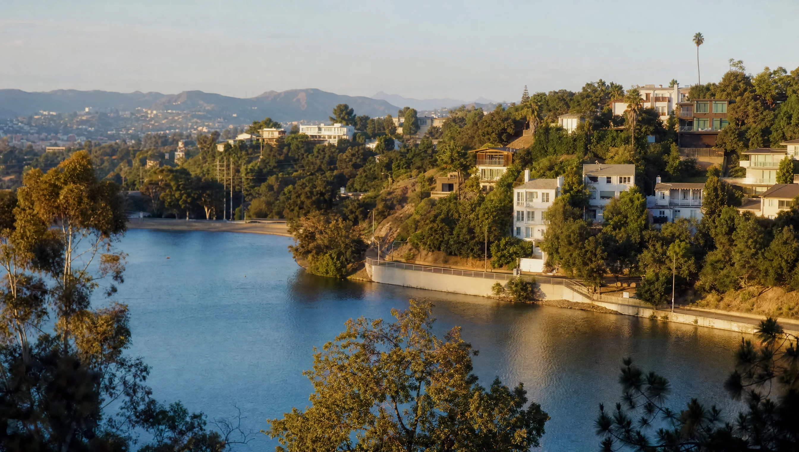 Silver Lake reservoir and hillside homes in warm Los Angeles light